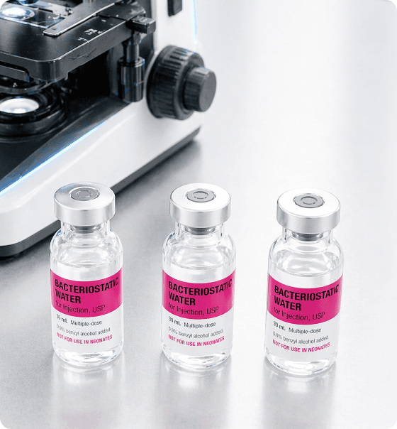 Bacteriostatic water vials beside a microscope